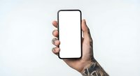 Hand holding smartphone with blank white screen mockup against neutral background for app presentation and digital marketing materials.