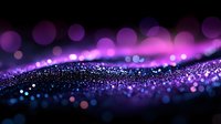 Magical purple and blue glowing particles flow in waves against dark background creating dreamy bokeh effect with blurred lights and sparkles.