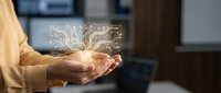 Businesswoman hands holding glowing digital circuit board hologram representing technology innovation and electronic engineering concepts in modern office.