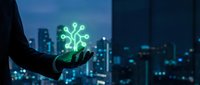 Businessperson holding glowing circuit board icon above night cityscape, representing digital transformation, technology innovation, and smart city development for corporate solutions.