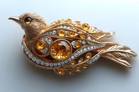 Luxurious golden bird brooch adorned with amber and clear crystals in elegant swirling design, featuring intricate metalwork details and delicate feather patterns.