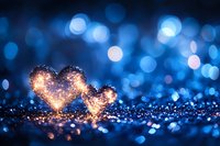 Glowing heart shapes created from golden sparkles against dark blue bokeh background with magical light effects and glitter for romantic occasions.