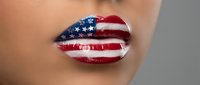 Patriotic lips painted with stars and stripes flag design for Independence Day celebration and national pride expression.