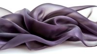 Elegant dark purple silk fabric with soft folds and waves creating luxurious flowing texture against white background, suitable for fashion and textile design projects.