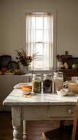 Rustic farmhouse kitchen with glass jars filled with grains and legumes on white wooden table, autumn decor and natural lighting for cooking content.