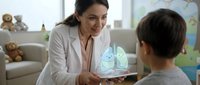 Female pediatrician showing lung anatomy on tablet to young patient in colorful medical office. Healthcare professional educating child about respiratory system.
