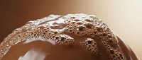 Close-up of chocolate sphere covered in cocoa powder, ideal for bakery, confectionery, and dessert marketing materials.