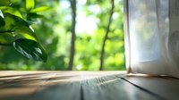 Sunlight streaming through window onto wooden floor with green forest view and white curtain, creating peaceful home atmosphere.