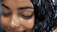 Young African American woman with glowing dewy skin and closed eyes smiling serenely, showcasing natural beauty and skincare results in macro photography.