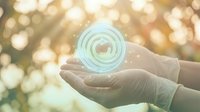 Hands holding glowing digital circle with warm bokeh background representing technology innovation and futuristic concepts for business presentations.