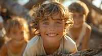 Joyful young Caucasian boy with curly hair and bright smile in natural sunlight outdoors, golden hour portrait with blurred background showing pure happiness.