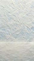 Handmade paper texture with natural fibers and organic patterns in soft blue and cream tones for craft and design projects.