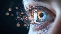 Close-up of human eye with glowing golden particles and bokeh effects dispersing into darkness, representing vision, technology, and digital transformation.