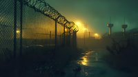 Prison security fence with barbed wire silhouetted against foggy sunset sky, guard towers visible in distance, dramatic moody atmosphere with reflective wet ground.