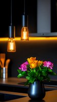 Modernful flower arrangement featuring yellow tulips and pink carnations in matte black vase on countertop.