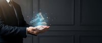 Businessman holding glowing holographic pyramid with floating particles in dark modern office environment for technology and innovation concepts.
