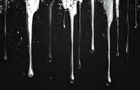 Liquid silver metallic drips and drops falling against dark background, creating dramatic contrast with splashing effect and flowing streaks in monochrome style.