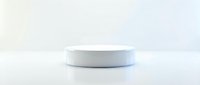 White round podium on a clean white background for product display, minimalist pedestal platform for cosmetics and retail presentation.