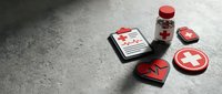 Medical healthcare icons with red cross symbols, clipboard, medicine bottle, and heart on dark concrete surface with copy space.