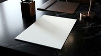 Blank white paper sheet on elegant black marble desk with leather notebook and copper pen holder in modern office workspace for business presentations.