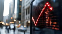 Red digital stock market graph showing upward trend against blurred urban financial district background with city lights.