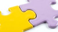 Bright yellow and lavender puzzle pieces interlocking together, symbolizing connection, teamwork, and problem-solving for business and educational concepts.