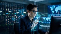Young Caucasian male IT specialist analyzing holographic data displays in futuristic control room with servers and world map screens for cybersecurity operations.
