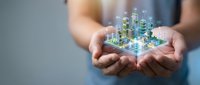 Hands holding holographic cityscape with glowing buildings and digital network connections, representing smart city technology, urban development, and future innovation for business concepts.