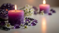 Purple candles burning with lavender flowers and gemstones creating peaceful spa atmosphere for relaxation and aromatherapy wellness treatments.