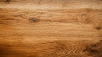 Natural oak wood texture with distinctive grain pattern and knots showing warm brown tones and organic lines, suitable for interior design backgrounds.