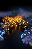 Glowing golden cubes with blue light particles on dark background create futuristic technology concept with selective focus and bokeh effect.