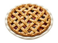 Homemade fruit pie with golden lattice crust and berry filling on white ceramic plate, ready for bakery, dessert, and food photography use.