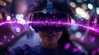 Young African American woman wearing virtual reality headset surrounded by glowing purple light trails and bokeh effects, expressing joy and wonder in futuristic setting.