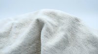 Soft, lightweight knit fabric with delicate ribbed texture in neutral cream tone, suitable for apparel design, fashion backgrounds, and textile projects.
