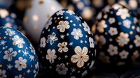 Decorative Easter eggs painted in deep blue with delicate white and gold floral patterns create elegant holiday composition against dark background.
