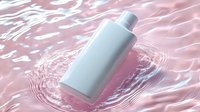 White cosmetic bottle floating in pink water with ripple effects, suitable for skincare, beauty product marketing, and wellness branding.