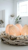 Glowing woven egg lanterns in a rustic wicker nest with dried moss, soft warm light, Easter spring decor in a bright white interior.