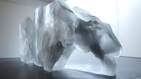 Large translucent ice crystal formation sculpture in modern gallery space with dramatic lighting and shadows on white walls and floor.