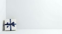 White gift box with navy blue ribbon bow on white background, isolated and ready for holiday, celebration, and promotional design use.