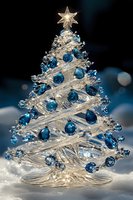 Crystal glass Christmas tree decorated with blue ornaments and illuminated star topper on snowy surface against dark background with bokeh lights.