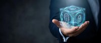 Businessman holding glowing digital cube with gear mechanisms in palm, representing innovation and technology solutions for modern business applications.
