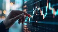 Hand pointing at financial trading chart with glowing candlestick graph on digital screen display, market analysis and investment concept in blue tones.