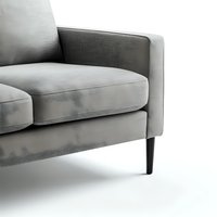 Modern gray velvet sofa with slim wooden legs on white background, cropped view showing minimalist design and luxurious upholstery texture.