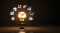 Glowing lightbulb with brain filament surrounded by business icons on dark background representing innovation, creativity and entrepreneurial thinking.