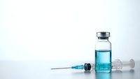 Medical vaccine vial with syringe on clean white background for healthcare and immunization campaigns.