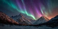 Vibrant aurora borealis with purple and green lights dancing over snow-covered mountain peaks at night, creating a magical winter landscape.