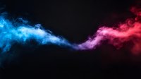 Vibrant blue and pink smoke streams collide dramatically against black background creating ethereal flowing abstract design with dynamic movement and contrast.