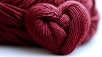 Red yarn twisted into heart shape on white background, perfect for Valentine's Day crafts, knitting projects, love-themed designs and romantic DIY decorations.