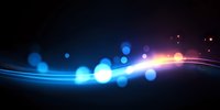 Abstract glowing blue and orange light waves with bokeh effect on dark background, creating dynamic motion and energy flow for technology designs.