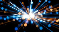 Dynamic light burst with radial streaks and bokeh effects creating motion blur and energy explosion on dark background for modern digital designs.